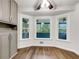 Bright breakfast nook featuring three large windows and wood-look flooring at 1280 Pinyon Pl, Lawrenceville, GA 30043