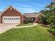 Charming brick home with a well-manicured lawn and attached two-car garage at 1280 Pinyon Pl, Lawrenceville, GA 30043