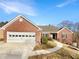 Charming brick home featuring an attached two-car garage and a well-maintained front yard at 1280 Pinyon Pl, Lawrenceville, GA 30043