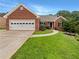 Charming brick home with a well-manicured lawn and a two-car garage at 1280 Pinyon Pl, Lawrenceville, GA 30043