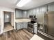 Updated kitchen with stainless steel appliances, and gray cabinetry at 1280 Pinyon Pl, Lawrenceville, GA 30043