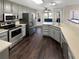 Spacious eat-in kitchen with stainless steel appliances, ample cabinet space, and gorgeous hardwood floors at 1280 Pinyon Pl, Lawrenceville, GA 30043