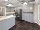 Charming kitchen featuring stainless steel appliances, beautiful cabinetry, and dark hardwood floors at 1280 Pinyon Pl, Lawrenceville, GA 30043