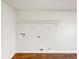 Bright laundry area features white walls, wooden floor, and convenient shelving at 1280 Pinyon Pl, Lawrenceville, GA 30043