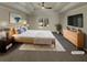 Bright main bedroom with a tray ceiling and large window overlooking the backyard at 1280 Pinyon Pl, Lawrenceville, GA 30043