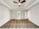 Large primary bedroom featuring a trey ceiling and neutral carpet at 1280 Pinyon Pl, Lawrenceville, GA 30043
