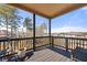 Relaxing outdoor porch with dark wood deck, black railings, and serene neighborhood views at 2880 Ridge Manor Dr, Dacula, GA 30019