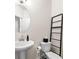 Stylish half-bathroom with modern fixtures including a pedestal sink and sleek decor at 2880 Ridge Manor Dr, Dacula, GA 30019
