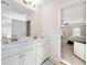 Elegant bathroom with double sinks, a white vanity, and easy access to the main bedroom at 2880 Ridge Manor Dr, Dacula, GA 30019