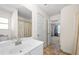 Bright bathroom with a large mirror, white cabinets, and doorway to another room at 2880 Ridge Manor Dr, Dacula, GA 30019