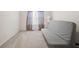 Simple bedroom with neutral carpeting, a futon couch, and sheer curtains at 2880 Ridge Manor Dr, Dacula, GA 30019