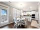 Eat-in kitchen with a table and chairs, door to the deck, and view of the kitchen at 2880 Ridge Manor Dr, Dacula, GA 30019
