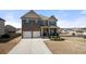 Charming two-story home with a brick facade, attached two-car garage, and a welcoming front porch at 2880 Ridge Manor Dr, Dacula, GA 30019