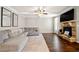 Inviting living room with a stone fireplace, ceiling fan, and large sectional sofa at 2880 Ridge Manor Dr, Dacula, GA 30019