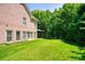 A well-manicured backyard features a grassy lawn, mature trees, and a brick home at 2938 Summitop Ne Rd, Marietta, GA 30066