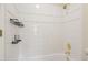 Clean white tiled shower/tub with gold fixtures and metal shelving at 2938 Summitop Ne Rd, Marietta, GA 30066