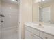 Bright bathroom featuring a white vanity, framed mirror, and tiled shower/tub combo at 2938 Summitop Ne Rd, Marietta, GA 30066