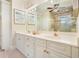Bright bathroom with dual sinks, white cabinetry, gold fixtures, and a shower at 2938 Summitop Ne Rd, Marietta, GA 30066