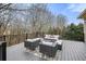 The home's backyard deck features grey wicker furniture and a leafy outdoor rug at 2938 Summitop Ne Rd, Marietta, GA 30066