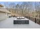 A grey deck with outdoor seating overlooking a private backyard and forest at 2938 Summitop Ne Rd, Marietta, GA 30066