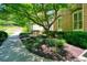 Beautifully landscaped front yard featuring lush greenery, mature trees, and a brick house at 2938 Summitop Ne Rd, Marietta, GA 30066