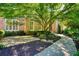 Charming brick home with lush landscaping, a winding walkway, and mature trees at 2938 Summitop Ne Rd, Marietta, GA 30066