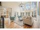 Open-concept living room with fireplace and expansive windows offering scenic views, seamlessly connected to the kitchen at 2938 Summitop Ne Rd, Marietta, GA 30066