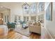 Bright living room with large windows, hardwood floors, and modern furnishings under a chandelier at 2938 Summitop Ne Rd, Marietta, GA 30066