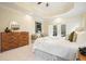 Bright main bedroom featuring a tray ceiling, private balcony, and wood dresser at 2938 Summitop Ne Rd, Marietta, GA 30066
