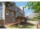 Back view of a two story house with wood siding, elevated deck, and fenced yard at 5060 Winship Ct, Alpharetta, GA 30009