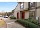 Condo exterior with well-manicured landscaping, red front doors, and convenient parking spaces at 707 Woodcliff Dr, Atlanta, GA 30350