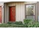 Charming condo entrance featuring a striking red door and lush green landscaping, enhancing curb appeal at 707 Woodcliff Dr, Atlanta, GA 30350