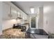 Updated kitchen featuring granite countertops and stainless steel appliances with natural light at 707 Woodcliff Dr, Atlanta, GA 30350