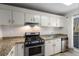 Updated kitchen featuring granite countertops and stainless steel appliances with natural light at 707 Woodcliff Dr, Atlanta, GA 30350