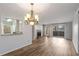 Open-concept living space with new flooring, fireplace, chandelier, and sliding glass doors to the outdoor space at 707 Woodcliff Dr, Atlanta, GA 30350