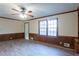 Comfortable living room with ceiling fan, wood paneling and updated vinyl flooring at 895 Smoketree Dr, Tucker, GA 30084