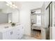 Modern bathroom features a double vanity, neutral walls, marble floors, and an open door to the bedroom at 142 Perimeter Walk, Atlanta, GA 30338