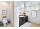Well-lit bathroom featuring a granite countertop, dark cabinetry, and neutral tile flooring at 142 Perimeter Walk, Atlanta, GA 30338