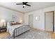 Bedroom featuring a ceiling fan, bed with a black frame, and a patterned rug at 142 Perimeter Walk, Atlanta, GA 30338