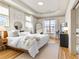 Bright and airy bedroom with hardwood floors, tray ceiling, and white walls at 142 Perimeter Walk, Atlanta, GA 30338