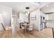 Inviting dining area with modern light fixture, hardwood floors, and access to the kitchen at 142 Perimeter Walk, Atlanta, GA 30338
