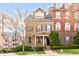 Charming brick townhome featuring a well-manicured front yard and a welcoming entrance at 142 Perimeter Walk, Atlanta, GA 30338