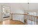 Second floor landing with decorative wood and iron railing leading to the bedrooms at 142 Perimeter Walk, Atlanta, GA 30338