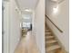 Hallway features hardwood floors, crown molding, and an adjacent staircase to the second floor at 142 Perimeter Walk, Atlanta, GA 30338
