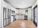 Modern kitchen featuring white cabinets, stainless steel appliances, and sliding door access at 142 Perimeter Walk, Atlanta, GA 30338