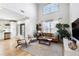 Bright living room boasts soaring ceilings, modern furnishings, and hardwood floors at 142 Perimeter Walk, Atlanta, GA 30338