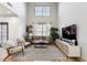Bright living room features soaring ceilings, hardwood floors, and stylish decor at 142 Perimeter Walk, Atlanta, GA 30338
