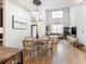 Open-concept living room with hardwood floors and dining area at 142 Perimeter Walk, Atlanta, GA 30338