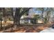 View of the exterior featuring a cute front yard, surrounded by mature trees at 2224 Elizabeth Se Ave, Smyrna, GA 30080