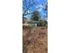 Home's exterior with a walkway leading to the entrance, set amidst a wooded landscape at 2224 Elizabeth Se Ave, Smyrna, GA 30080